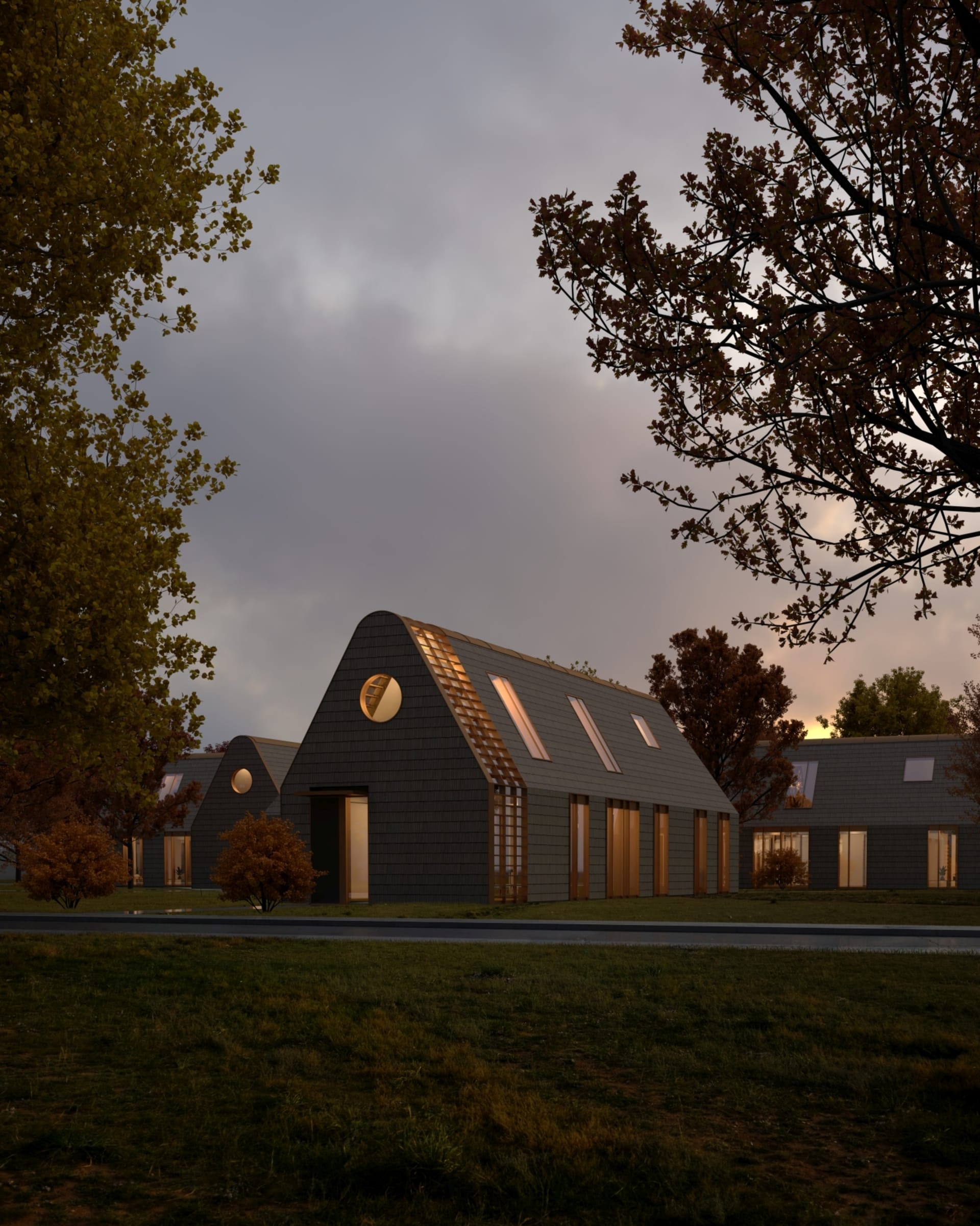 A gray communal house with trees and grass